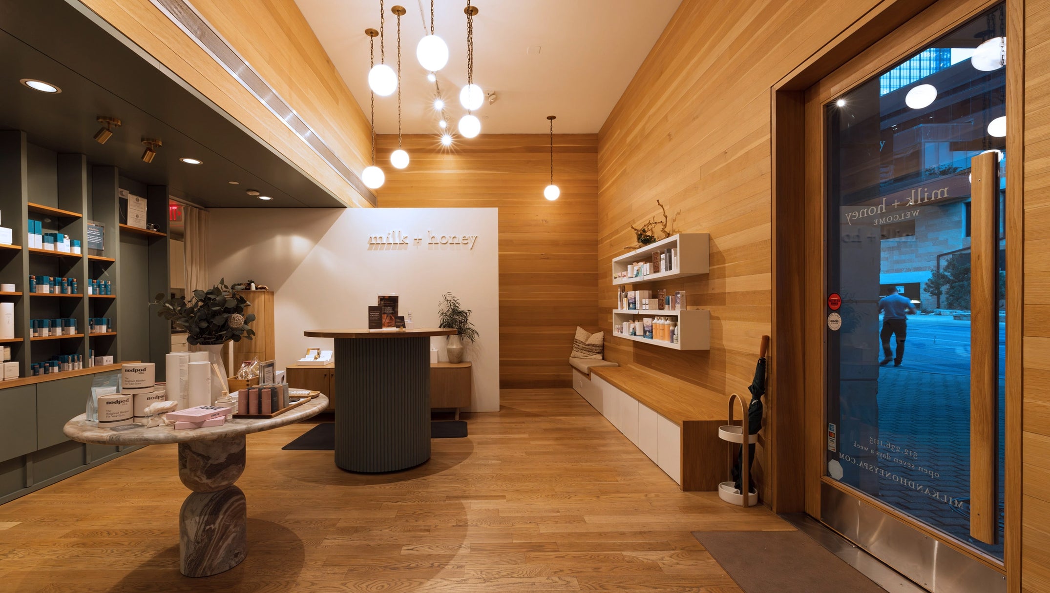 Modern interior design of a store with wooden walls and a glass door.