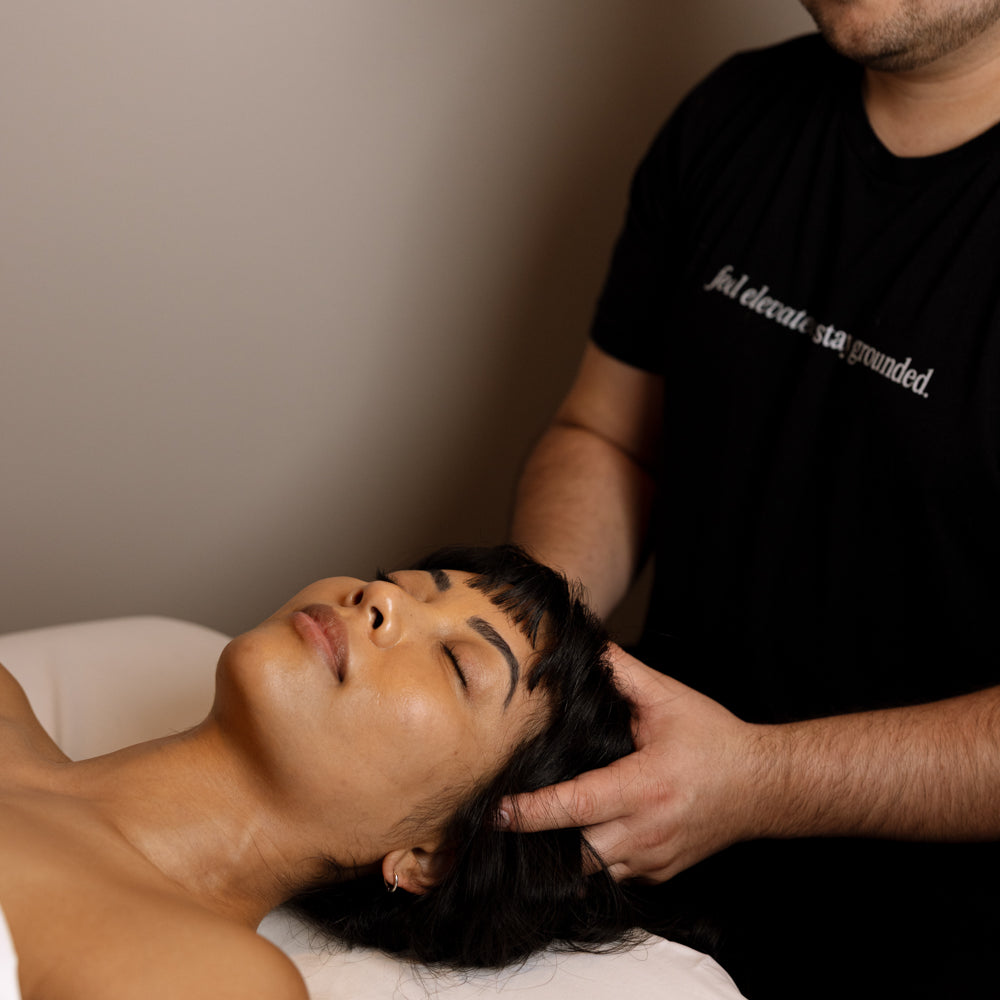 Person receiving a massage from another person in a clinical setting.