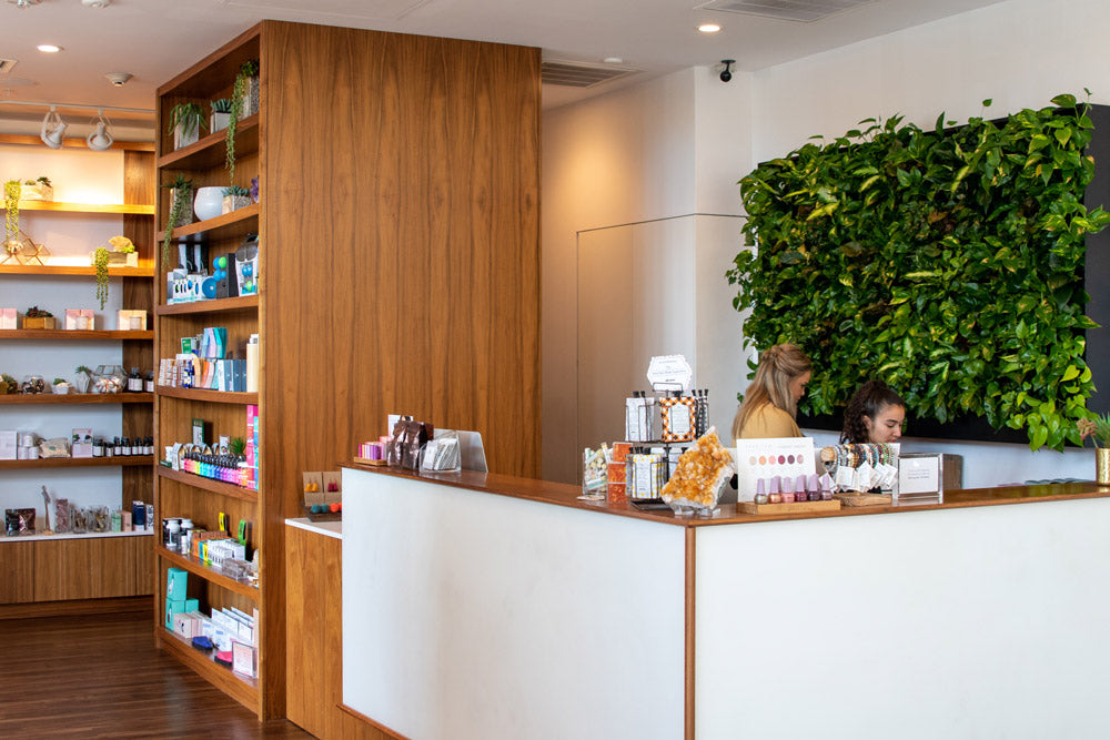 Modern interior with a reception desk and bookshelf in a well-lit room.