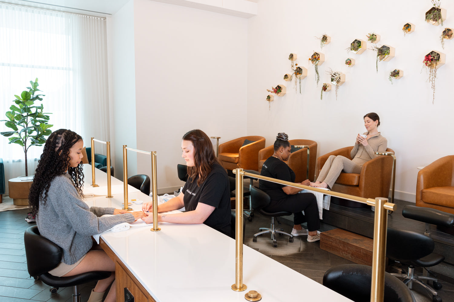 People sitting in a modern waiting room with a reception desk.