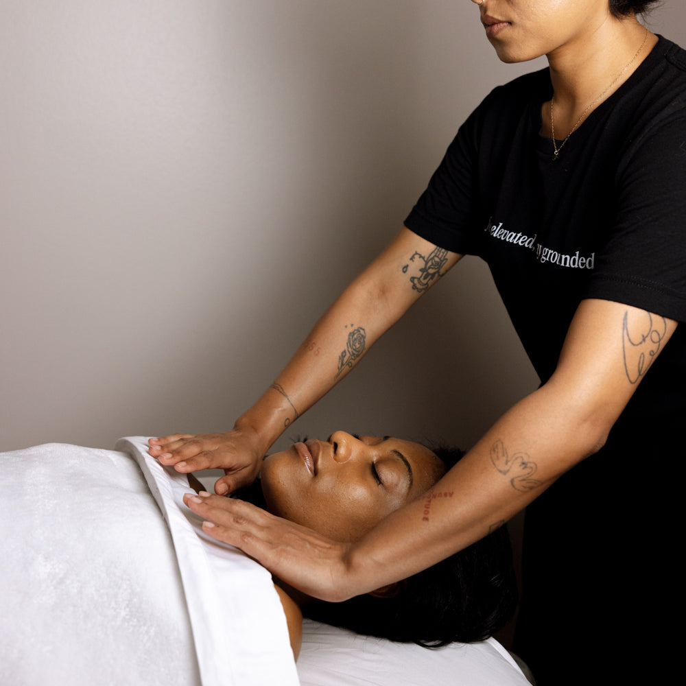 Person receiving a massage from another person in a clinical setting.
